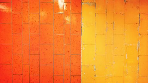 Full frame of yellow and orange wall tiles