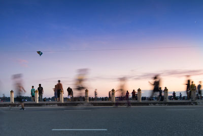 People in city at sunset