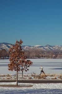 Scenic view of snow covered mountains against clear sky