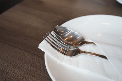 High angle view of fork in plate on table