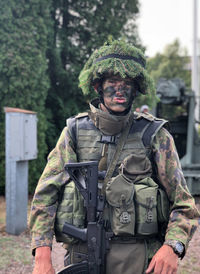Portrait of man standing in camouflage clothing