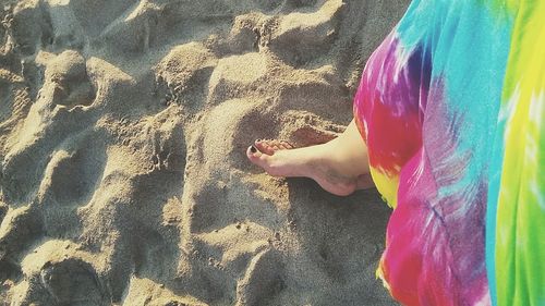 Low section of person standing on beach