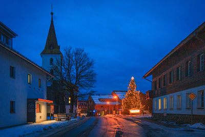 Illuminated buildings against sky at night