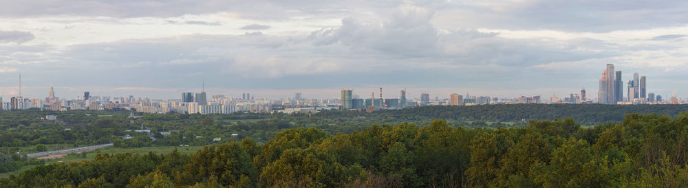 Panoramic view of cityscape against cloudy sky