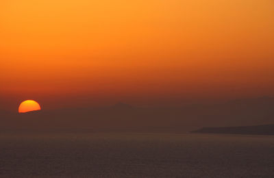 Scenic view of sea against orange sky