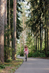 Rear view of woman walking in forest