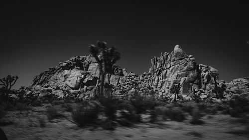 Low angle view of rocks against sky