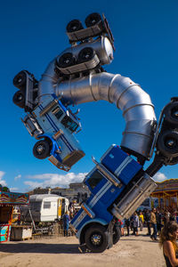 Low angle view of machine against clear blue sky