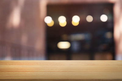 Defocused image of illuminated lights on table