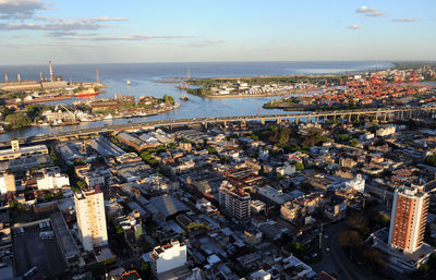 High angle view of townscape by river against sky