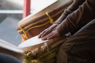 Cropped image of man playing traditional drum