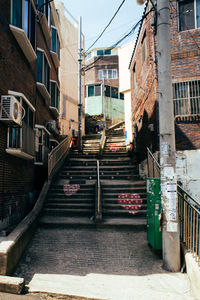 Staircase in city against sky