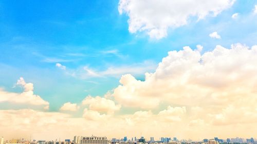 Panoramic view of cityscape against blue sky