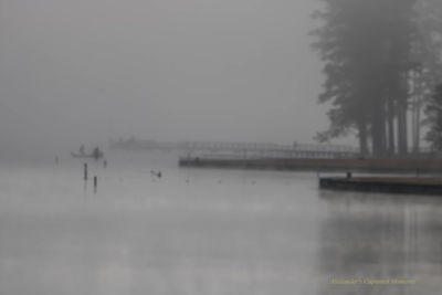 Scenic view of lake against sky during winter