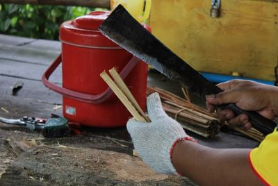 Midsection of man working on wood