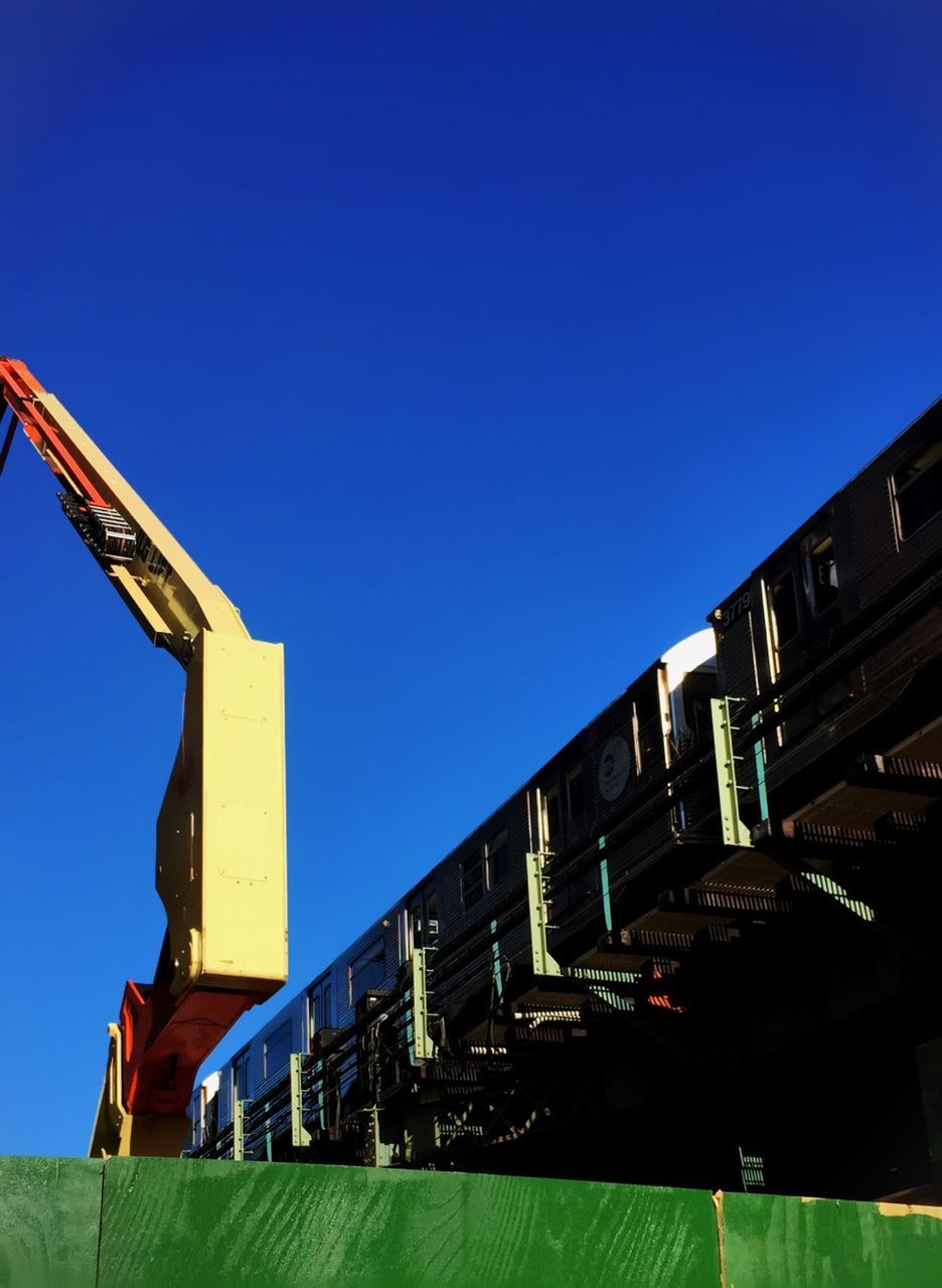 clear sky, architecture, built structure, low angle view, copy space, building exterior, blue, illuminated, night, connection, outdoors, bridge - man made structure, city, transportation, communication, no people, building, engineering, dusk