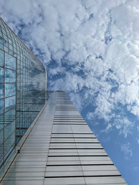 Directly below shot of glass building against sky