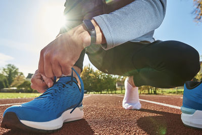 Runner get ready for run, tying sneakers shoelaces