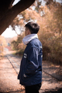 Side view of young man standing on land