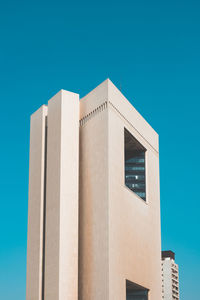 Low angle view of building against blue sky