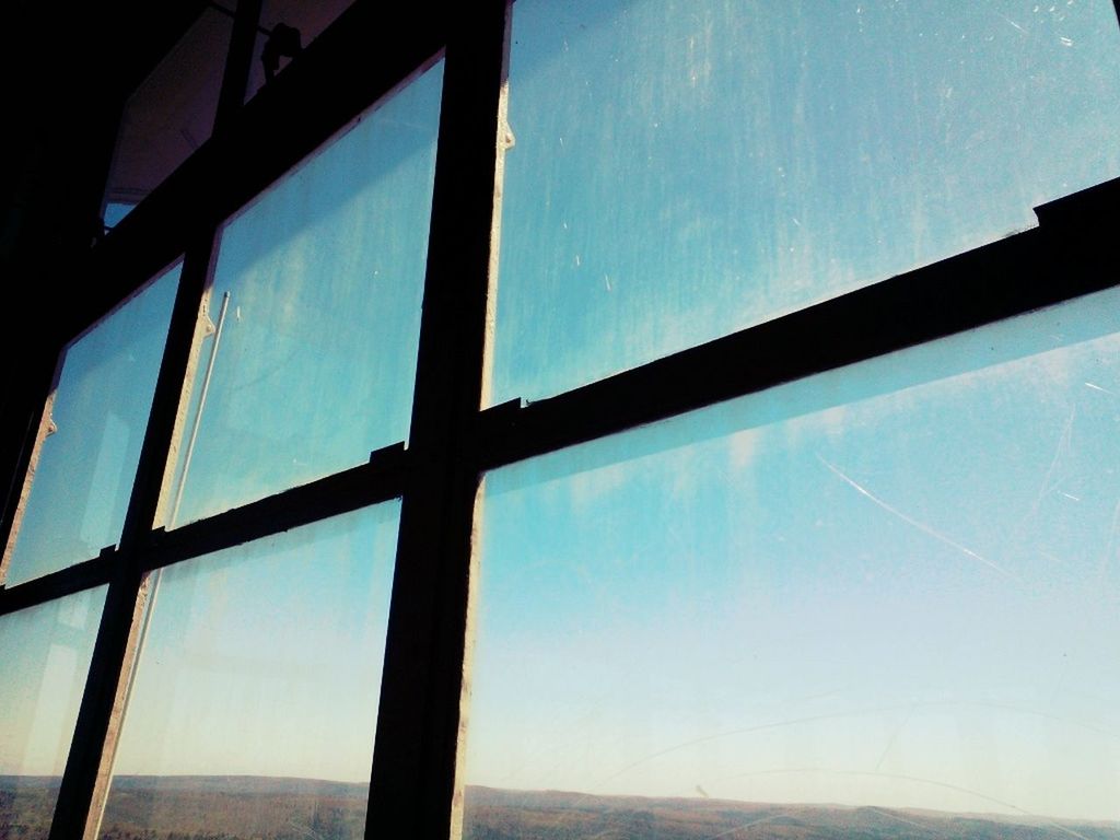 blue, window, sky, glass - material, low angle view, transparent, indoors, built structure, architecture, reflection, day, no people, sunlight, sea, cloud, cloud - sky, nature, glass, pattern