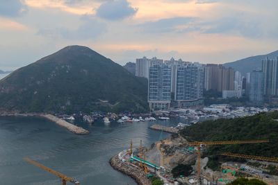 High angle view of buildings by sea against sky