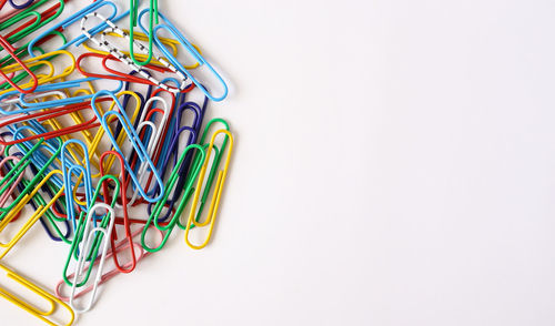 High angle view of multi colored pencils on white background