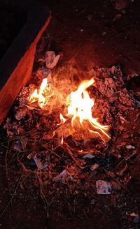 High angle view of bonfire on field at night