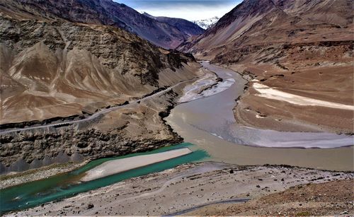 Muddy zanskar river  joins the blue indus at nyemo in central ladakh, ladakh region, india