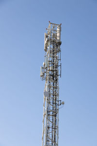 Low angle view of communications tower against clear sky