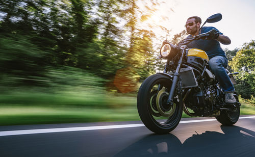 Man riding motorcycle on road