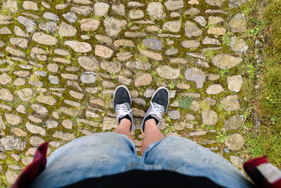 Low section of man standing on street