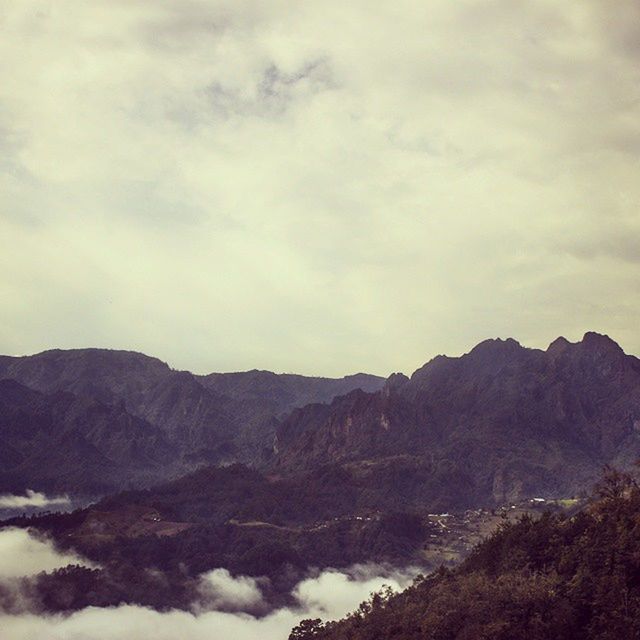 mountain, tranquil scene, scenics, tranquility, sky, mountain range, beauty in nature, cloud - sky, nature, landscape, cloudy, non-urban scene, idyllic, cloud, outdoors, remote, day, no people, weather, non urban scene