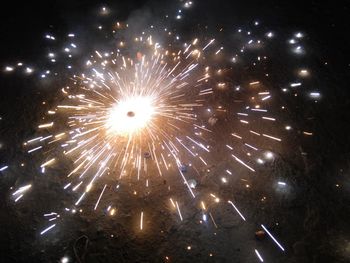 Low angle view of firework display at night