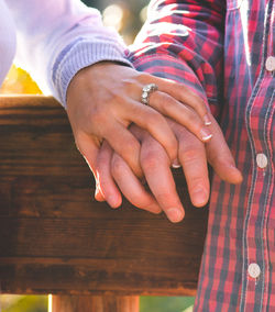 Cropped image of couple holding hands