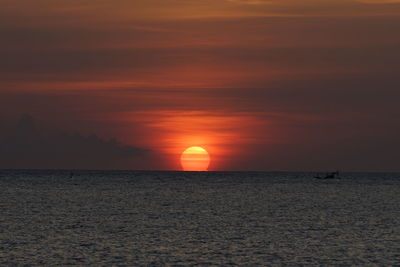 Scenic view of sea against romantic sky at sunset