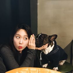 Woman listening to dog at home