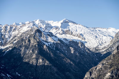 Scenic view of snowcapped mountains against clear sky