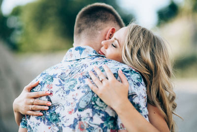 Midsection of couple kissing