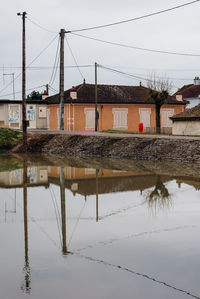 Reflection of built structure in puddle