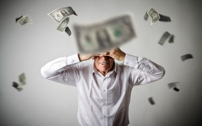 Mid adult man standing against white background