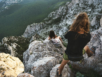 Rear view of woman walking on rocks