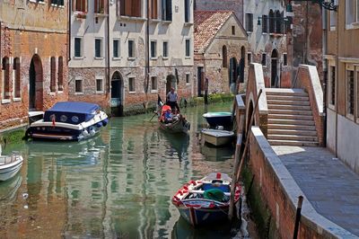 High angle view of boats in canal along buildings