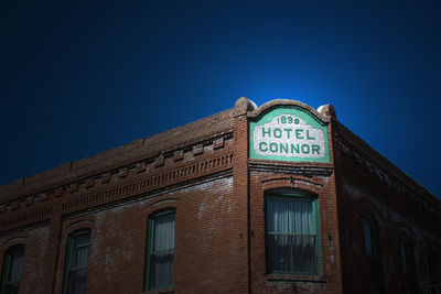 Low angle view of building against clear blue sky