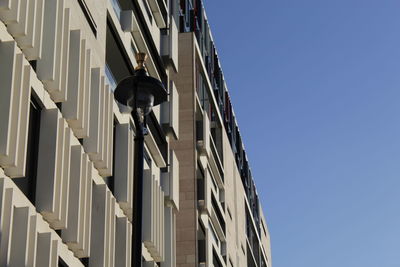 Low angle view of street light against building