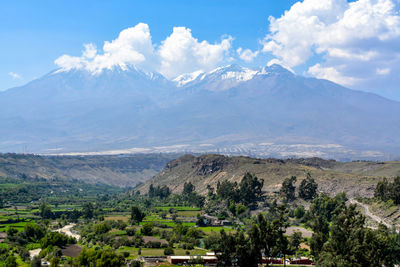 Scenic view of landscape and mountains against sky