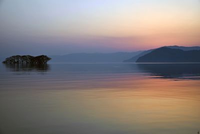 Scenic view of sea against romantic sky at sunset