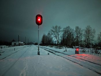 Snow covered road against sky during winter