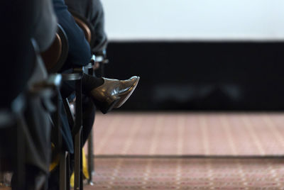 Low section of person sitting on seat