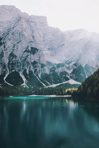 Scenic view of lake by mountains against sky